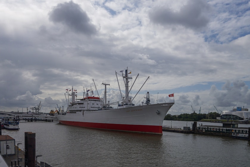 a large white and red boat in the water