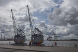A group of participants observing large cargo cranes at the port during a guided tour.