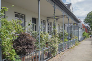 Sunlit balcony overlooking tree-lined streets typical of Buenos Aires residential areas