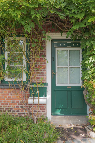 The inviting entrance of the house with a vintage lantern and climbing ivy.