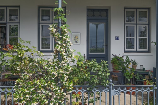 A 40ft ADU exterior painted in soft gray with a welcoming front porch and potted plants.