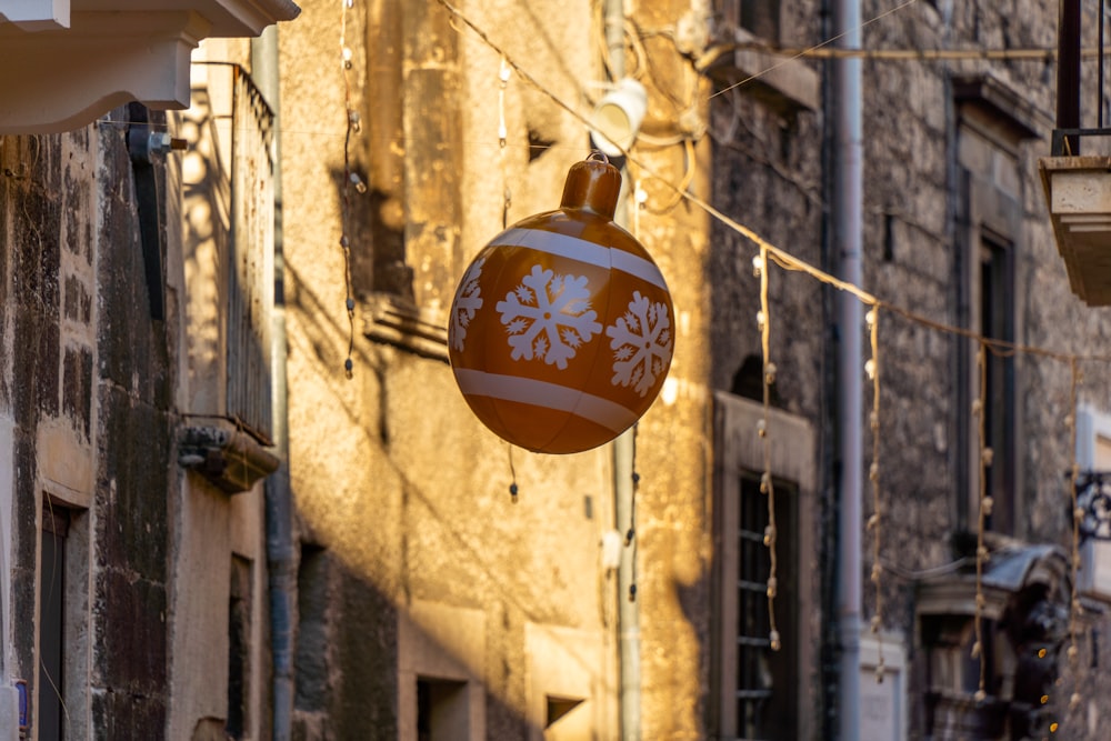 a christmas ornament hanging from a line of buildings