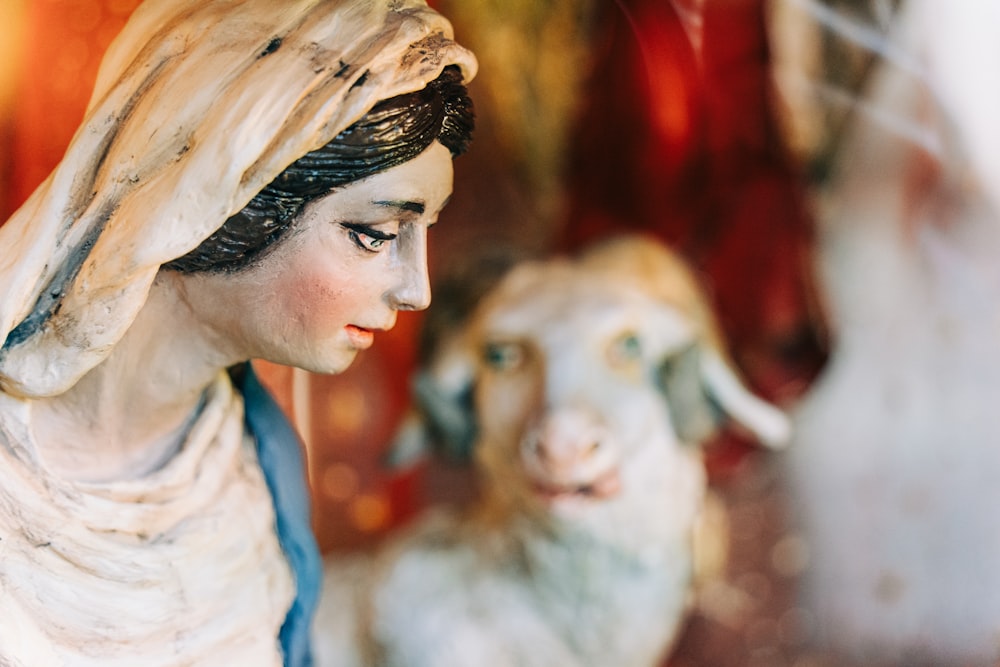 a statue of a woman and a sheep