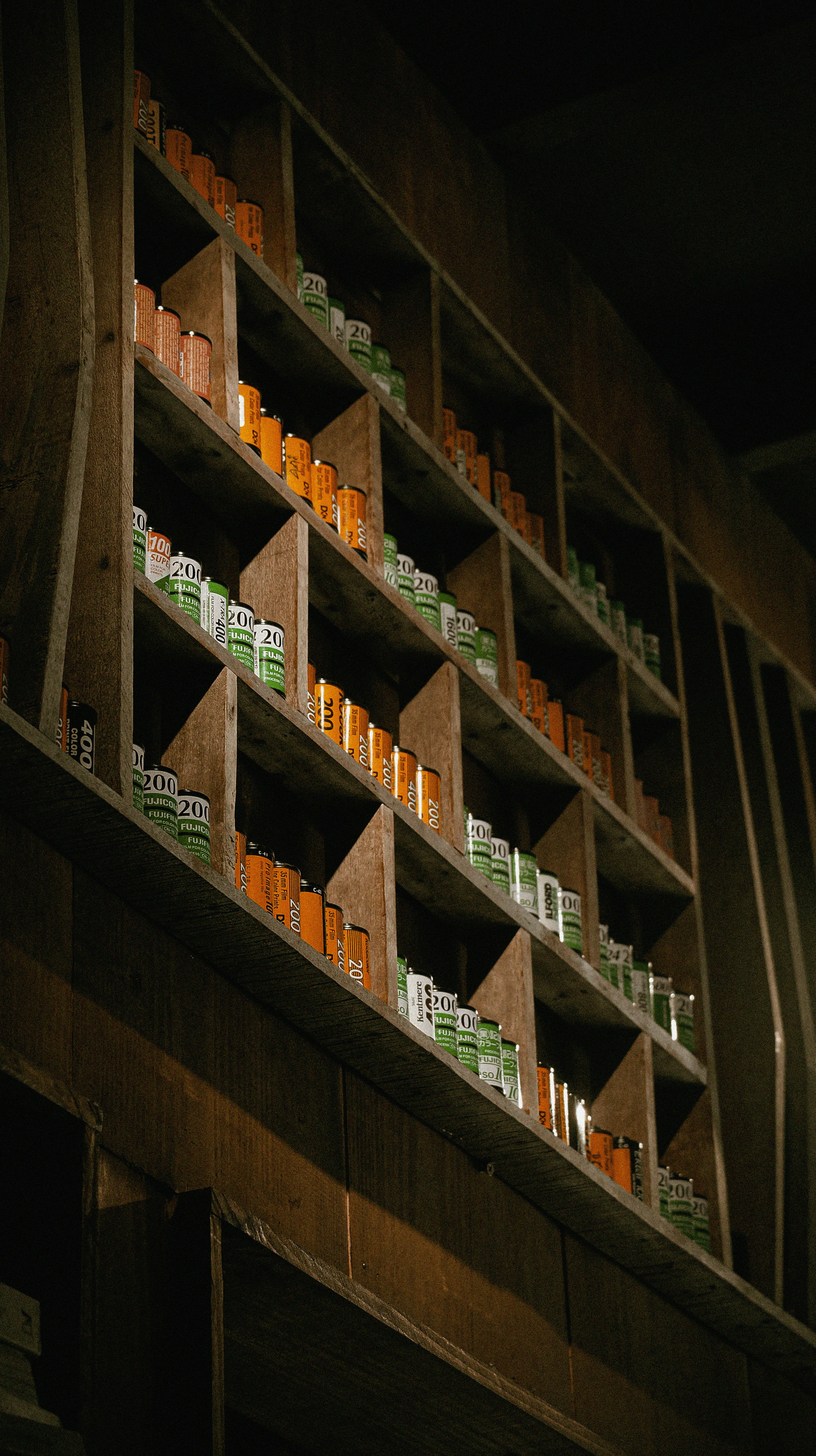 a wooden shelf filled with lots of bottles