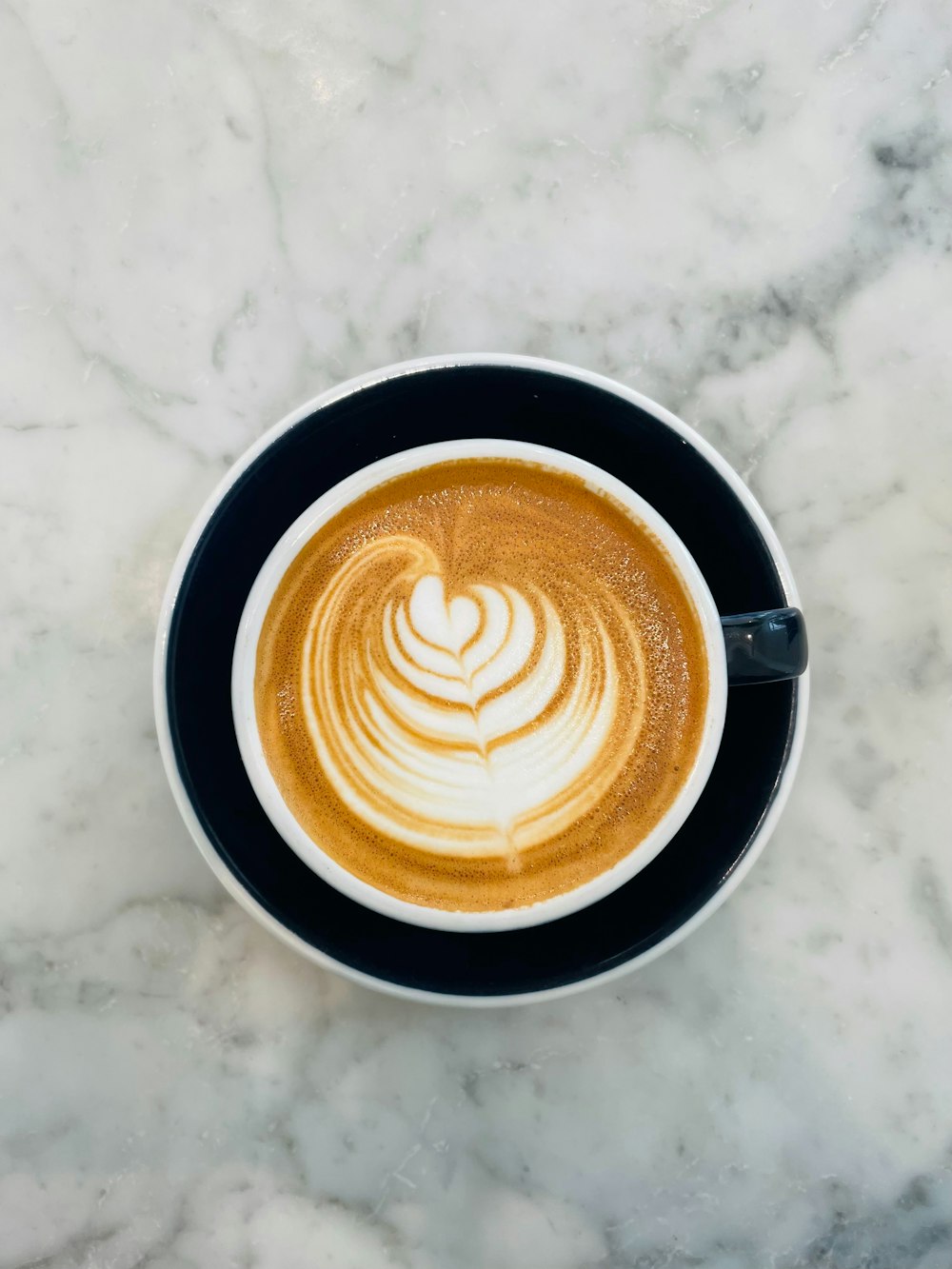 a cup of coffee on a marble table