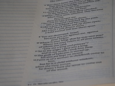 A close-up image of a page from a book, featuring printed text in English. The text is formatted in a poetic or paragraph style with numbered sections, suggesting it is part of a larger document, possibly religious or literary in nature.