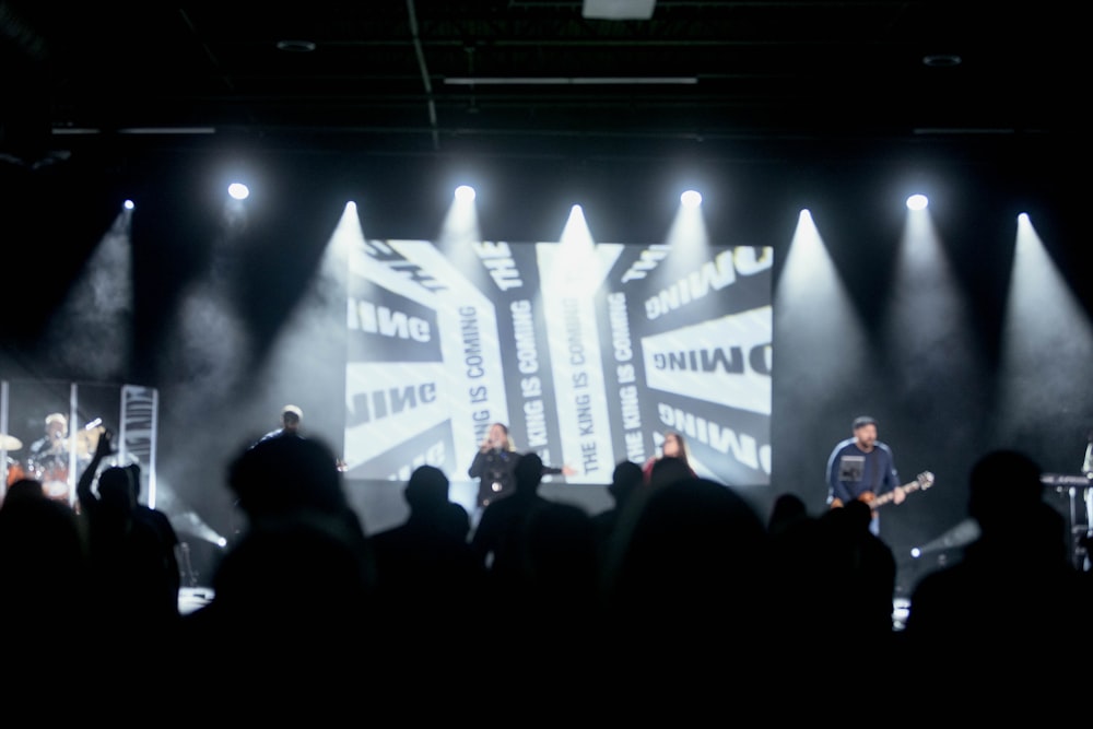 a group of people standing on top of a stage