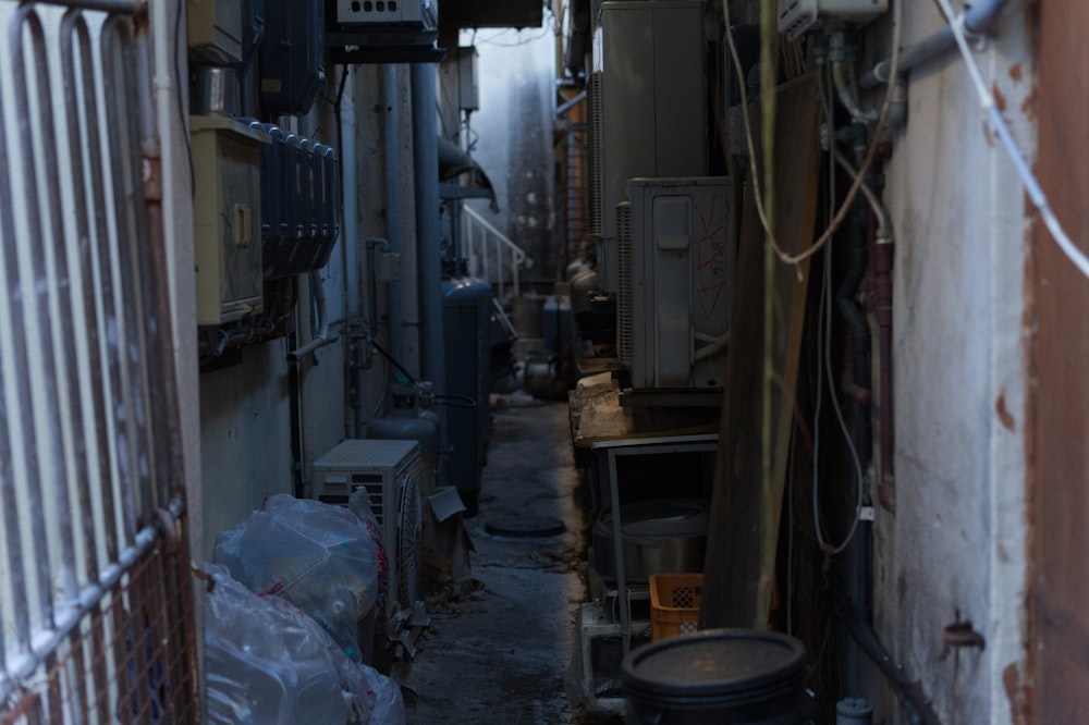 a narrow alley way with lots of electrical equipment