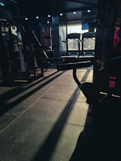 a gym with a row of exercise equipment