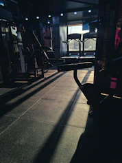 a gym with a row of exercise equipment