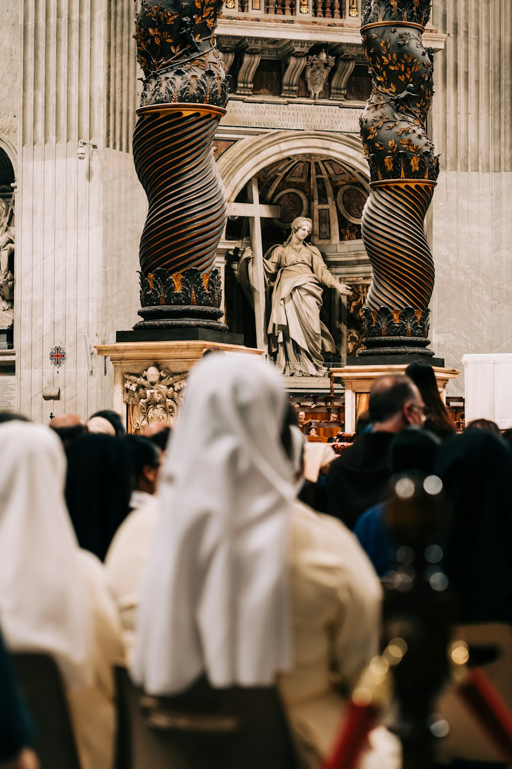 a group of people standing in front of a statue