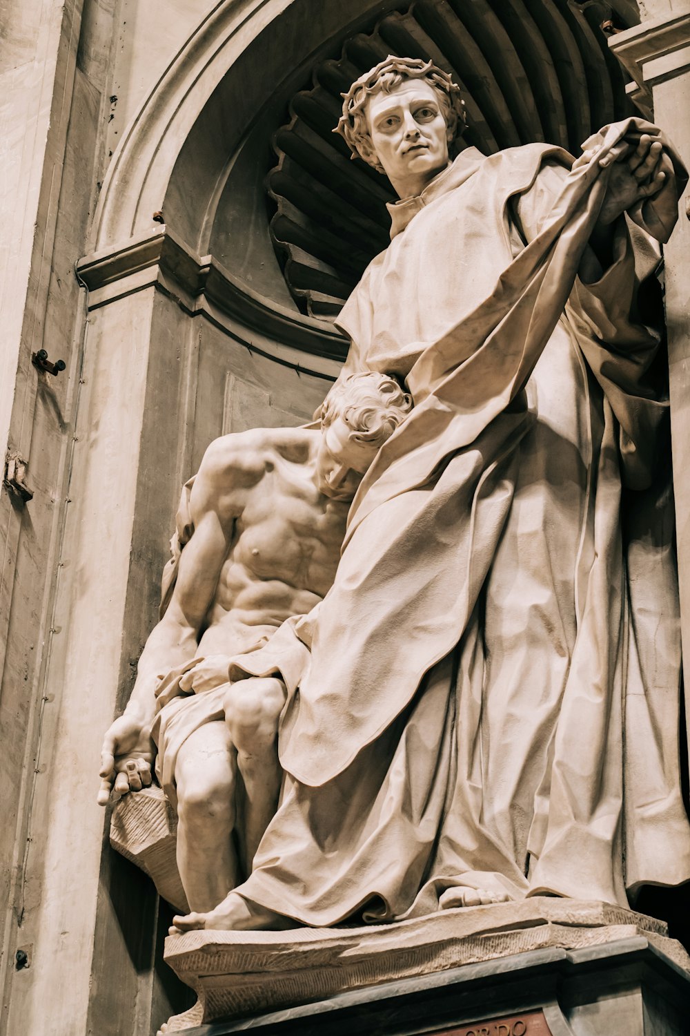 a statue of a man standing next to a building