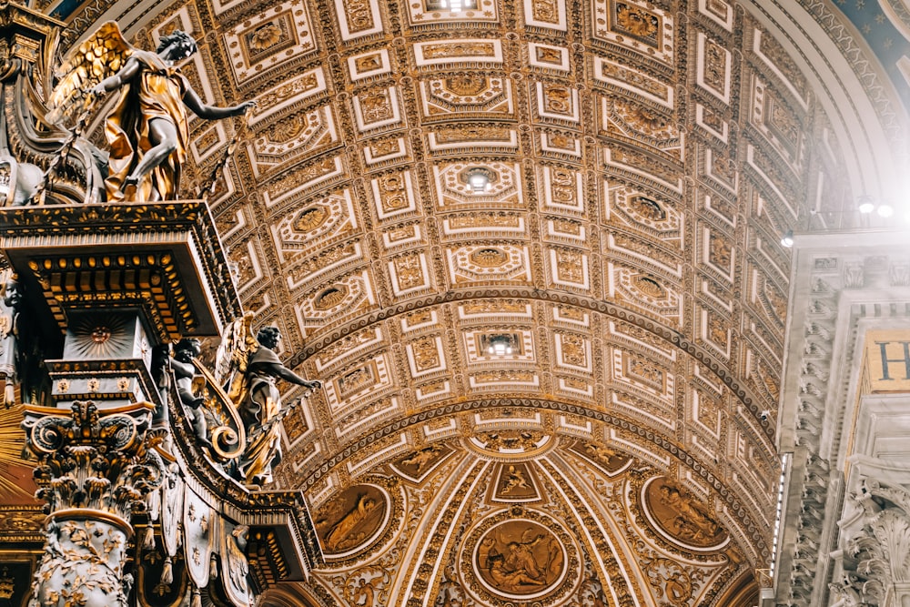 the ceiling of a church with a statue on it