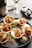 A beautifully arranged seafood platter featuring oysters and gourmet ham on a rustic wooden table.
