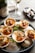A beautifully arranged seafood platter featuring oysters and gourmet ham on a rustic wooden table.