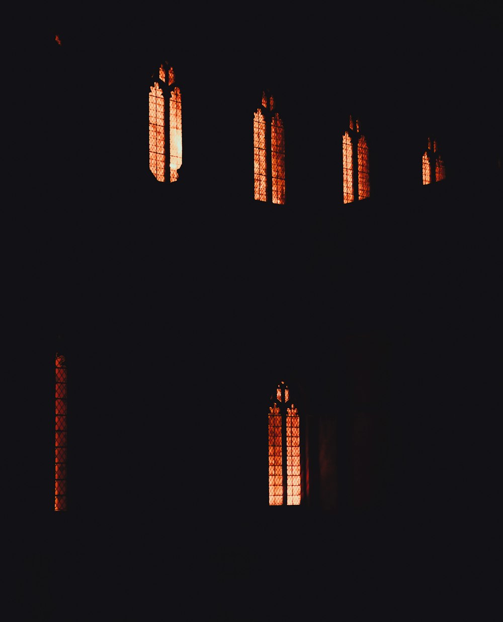 a building with many windows lit up in the dark