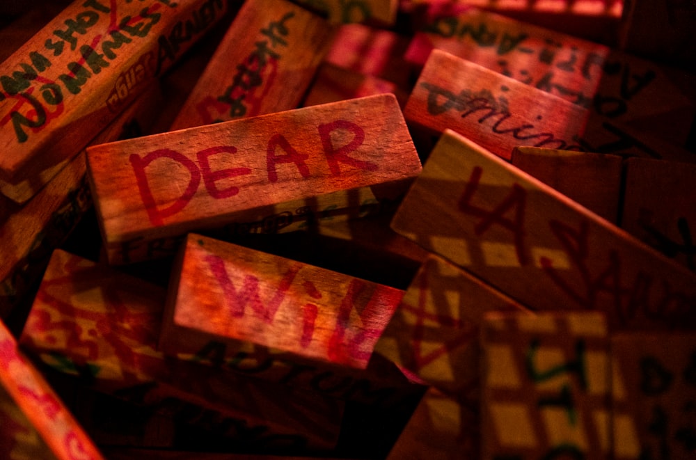 a pile of wooden blocks with the word dear written on them