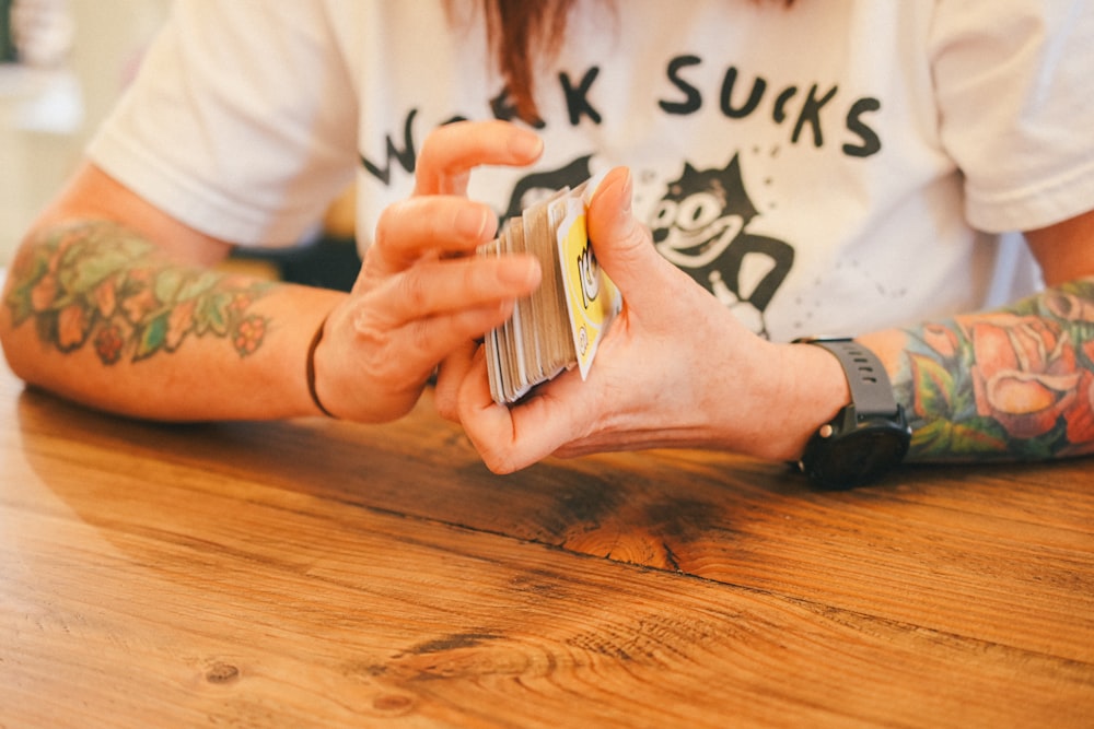 a person sitting at a table with a cell phone