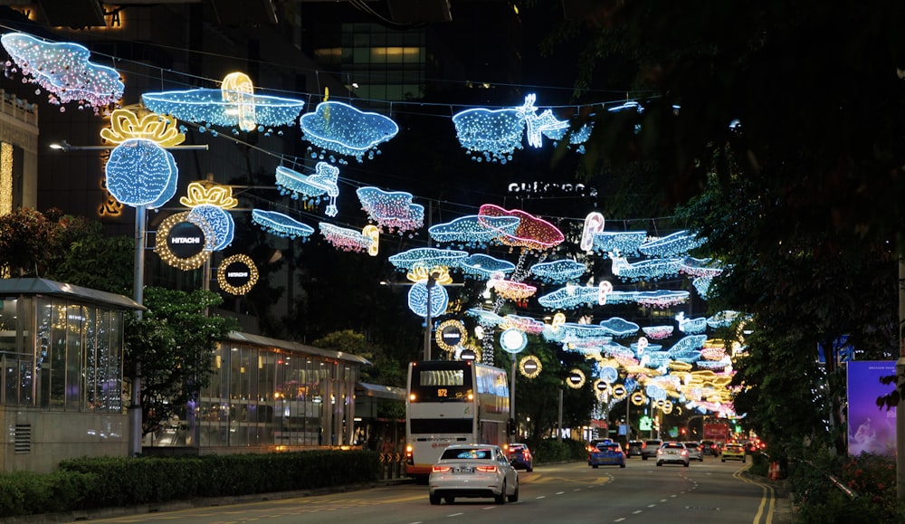 a car driving down a street covered in christmas lights