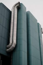 a large metal pipe is attached to the side of a building