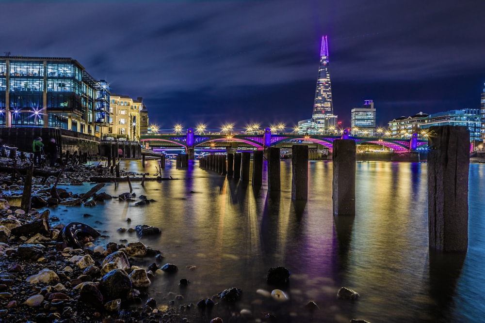 a city skyline with a bridge over a body of water