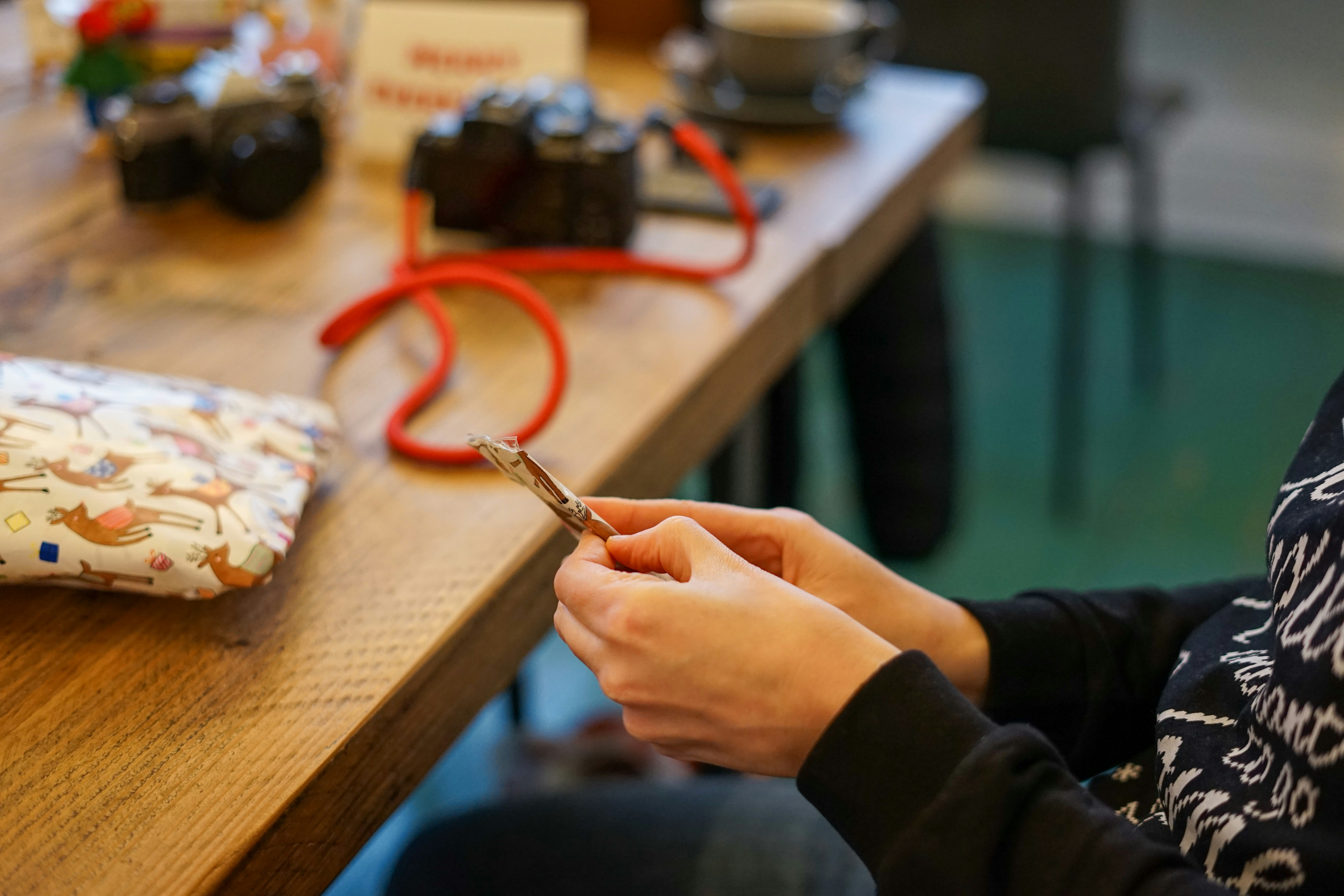 a person sitting at a table with a cell phone