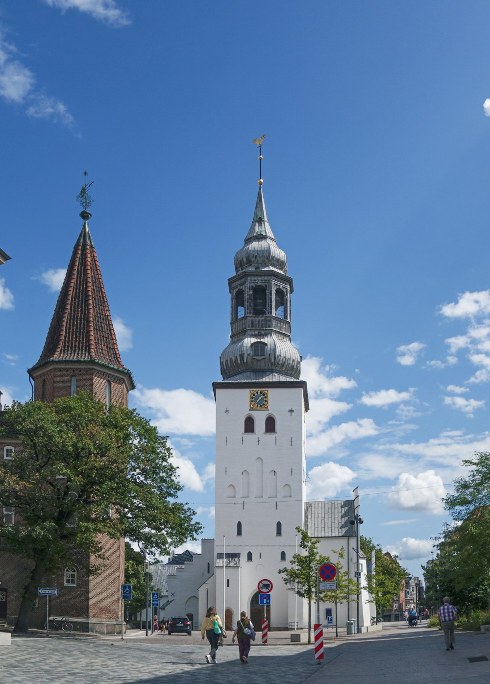 a tall white tower with a clock on it's side