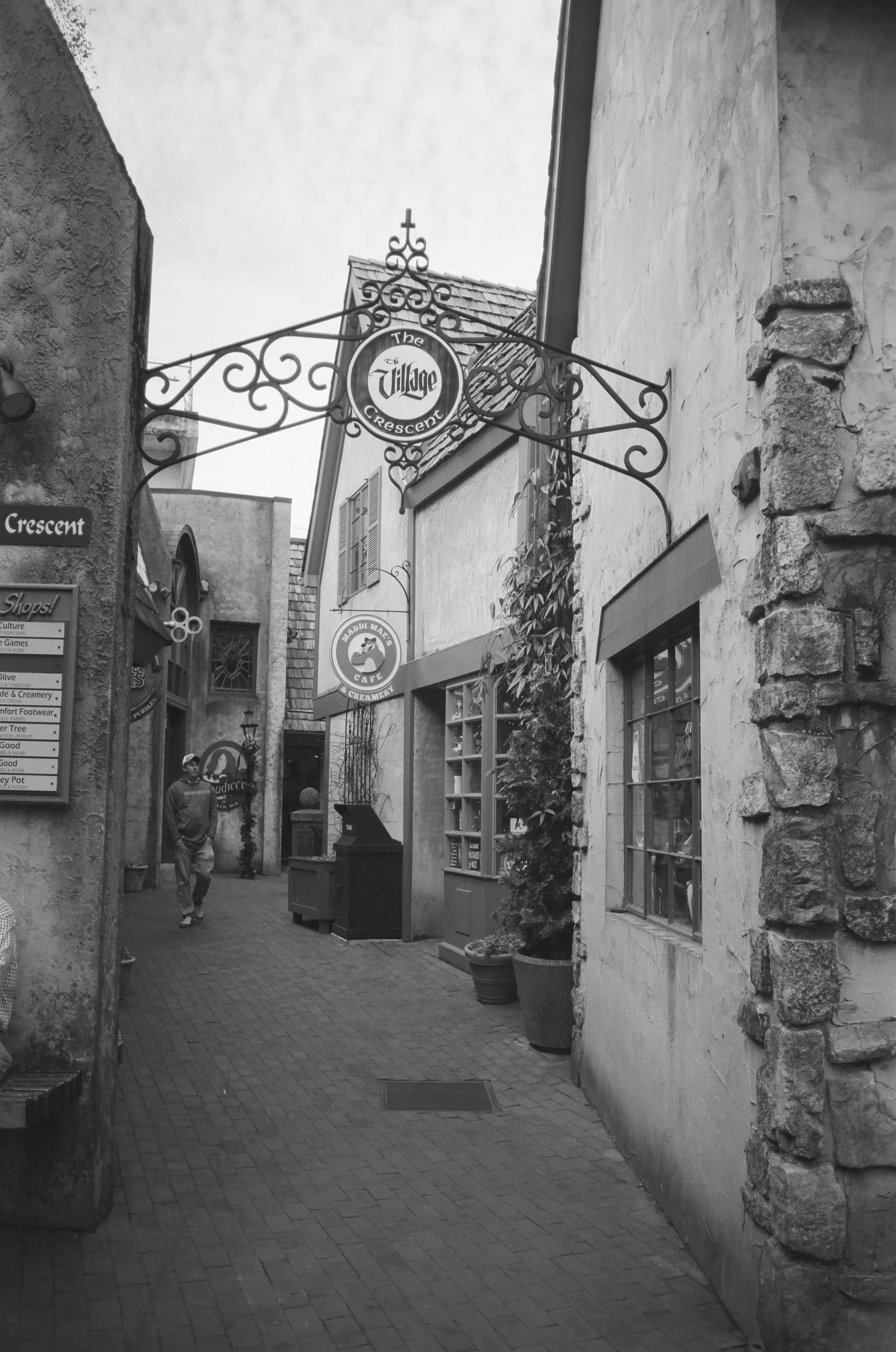 a black and white photo of a narrow street