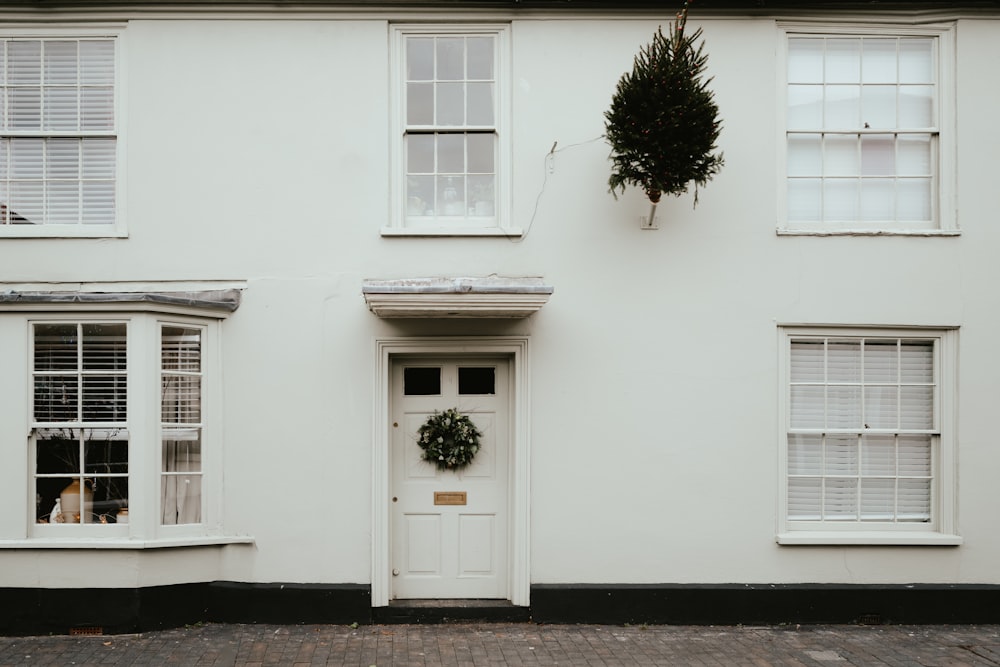 a white house with a wreath on the front door