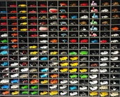 A vibrant display of various 1:64 scale model cars in a store setting.