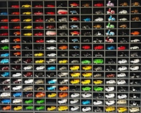 A display of various car spare parts neatly organized on shelves.