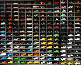 A vibrant display of various 1:64 scale model cars in a store setting.