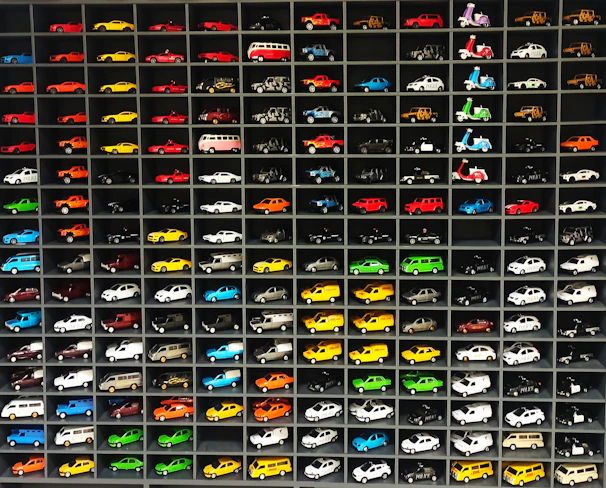 A colorful display of electric toy cars and bikes arranged neatly inside Sri Bhavish Toy House in Bengaluru.