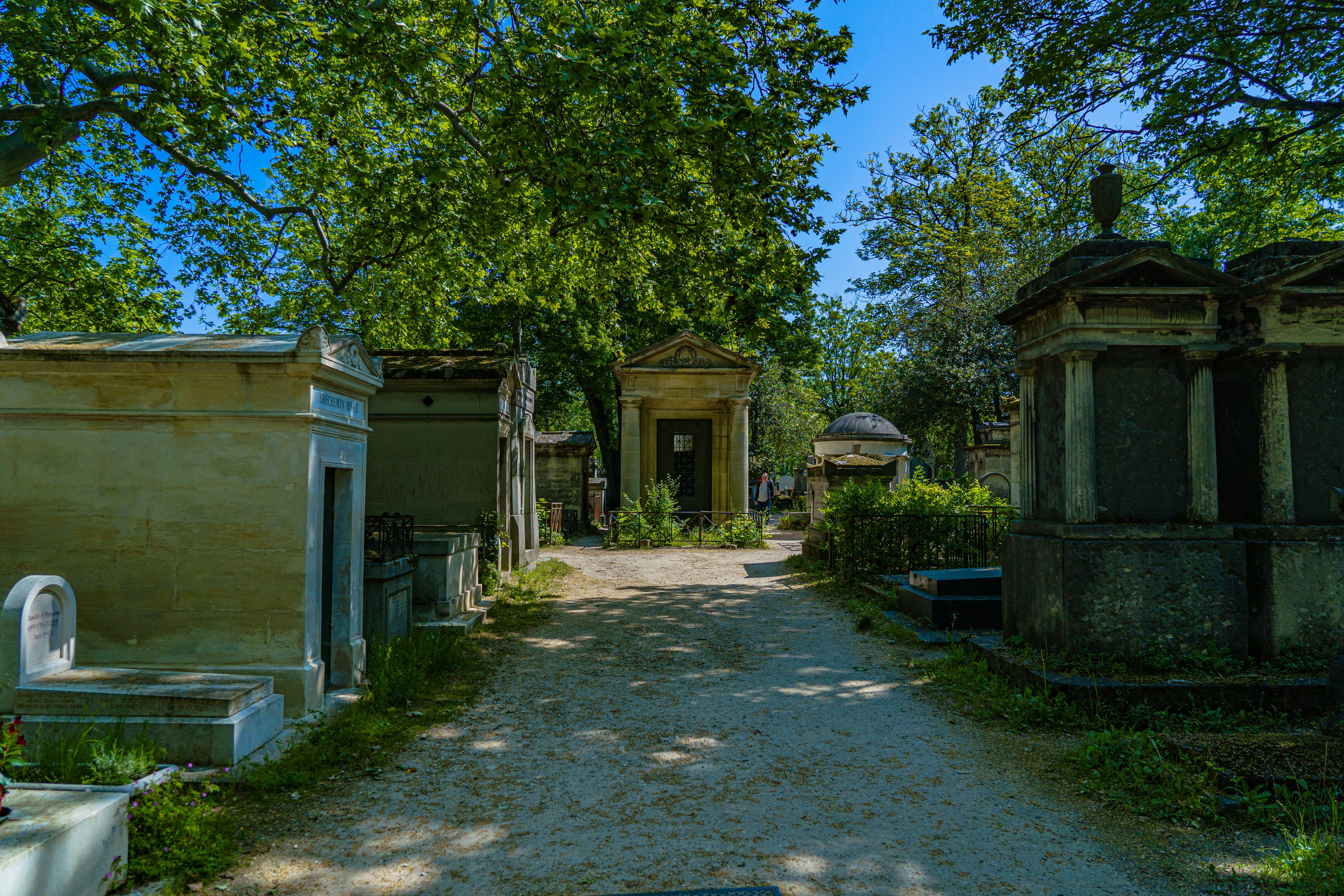a dirt road that has a bunch of buildings on it