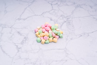 Close-up of authentic lucky charms resting on a white marble surface with warm gold tones.