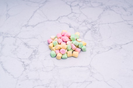 Close-up of authentic lucky charms resting on a white marble surface with warm gold tones.