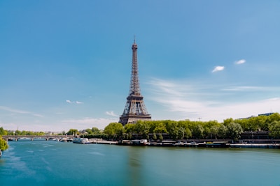 A scenic view of the Eiffel Tower with a clear blue sky in the background.