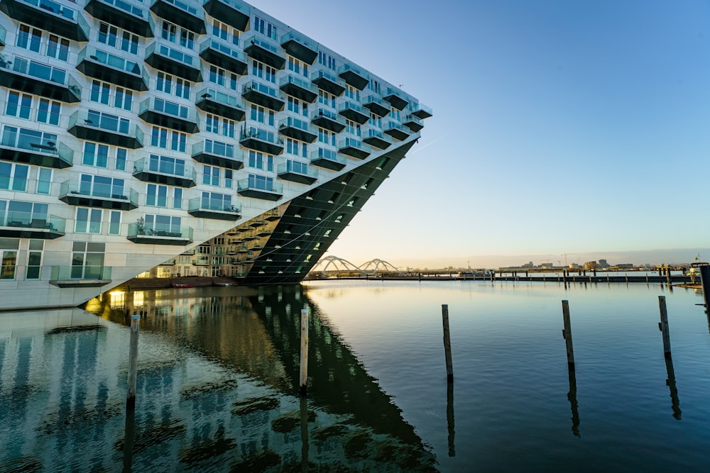 a very tall building sitting next to a body of water