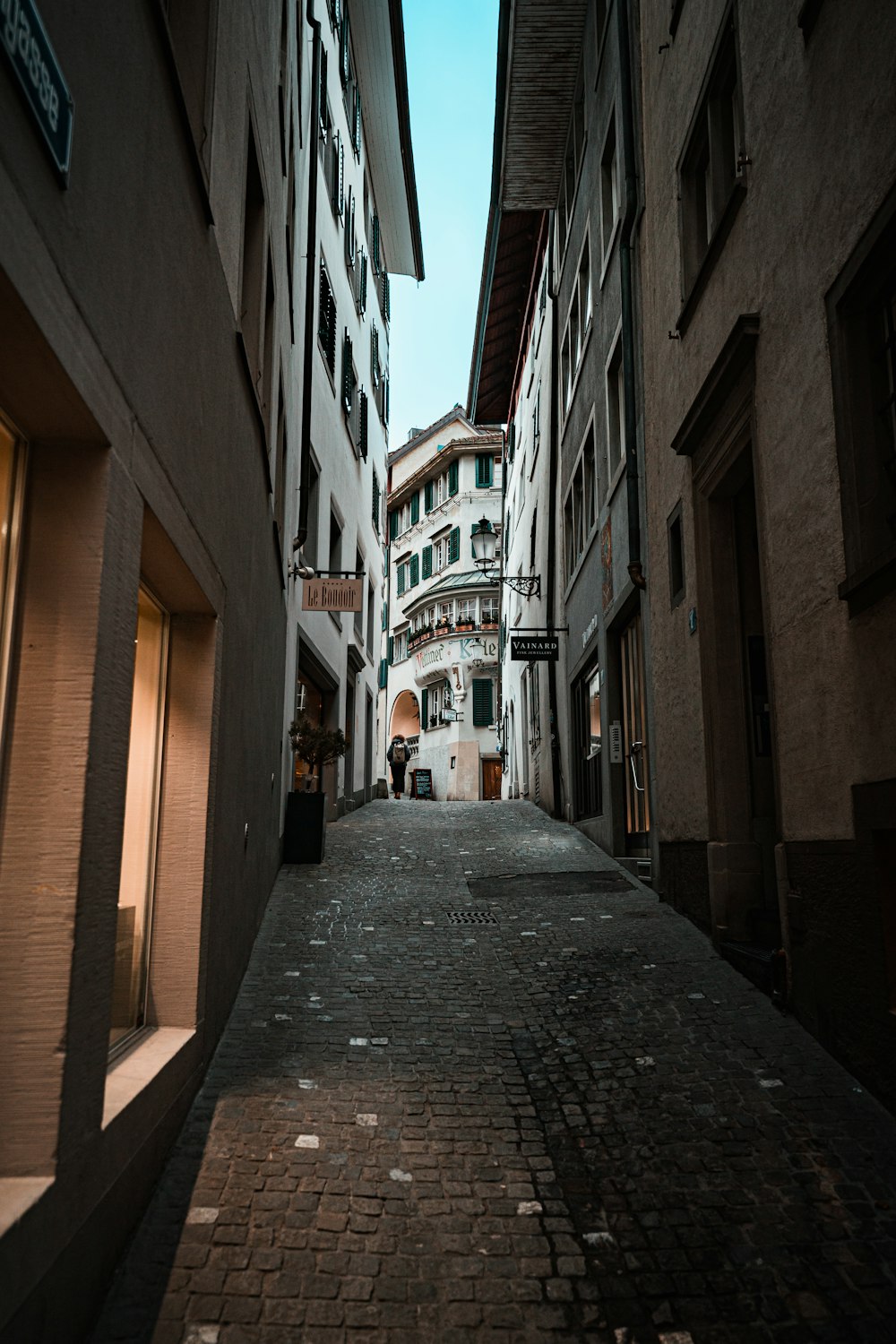 a narrow city street with buildings on both sides