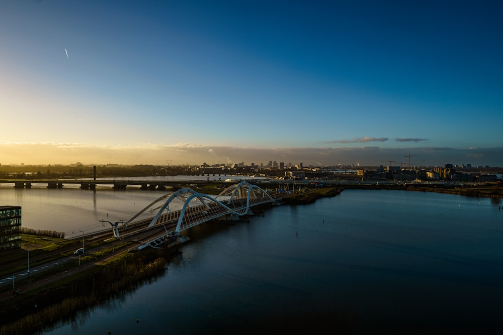 a bridge over a body of water with a city in the background