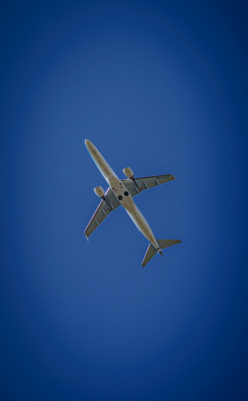 a large airplane flying through a blue sky