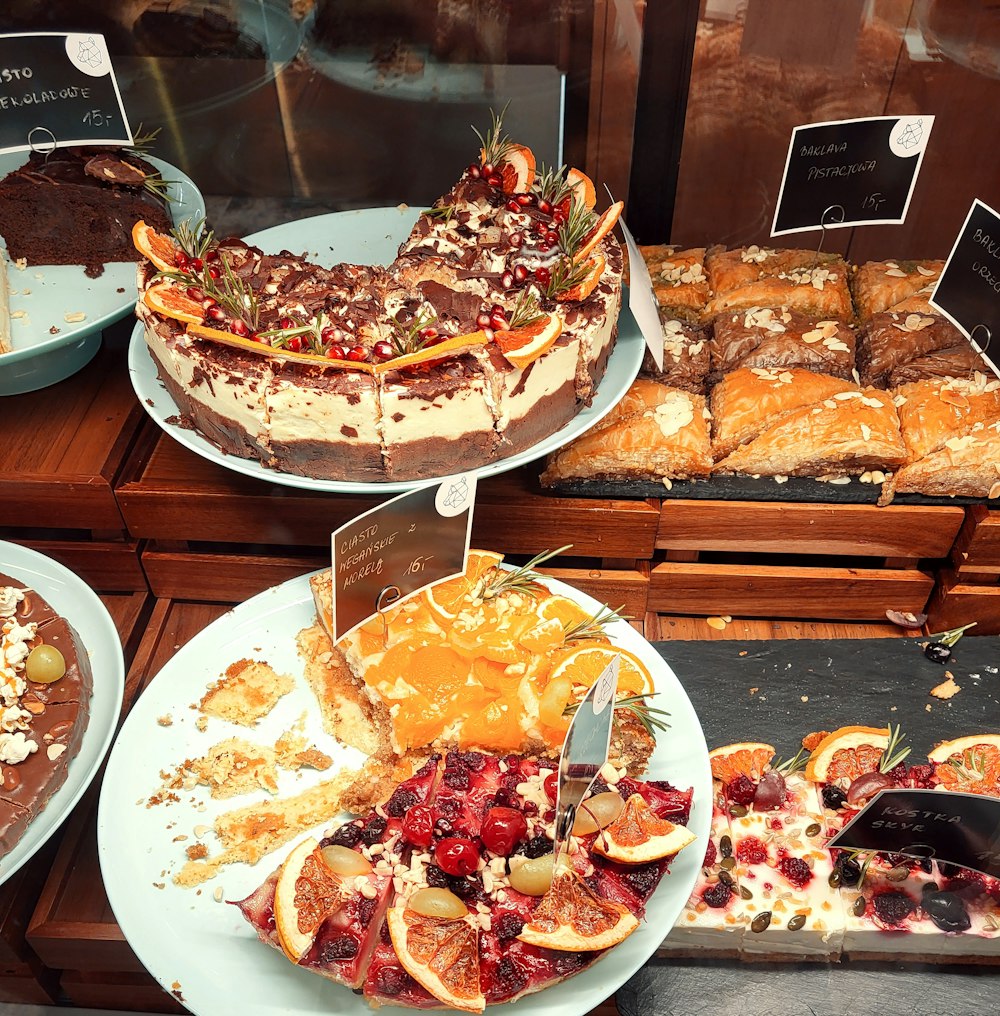 a display case filled with lots of different types of cakes