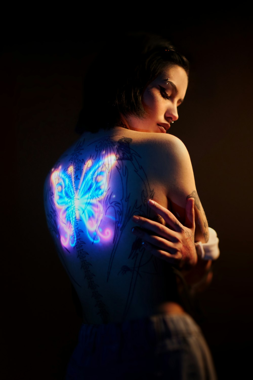a woman with a butterfly tattoo on her back