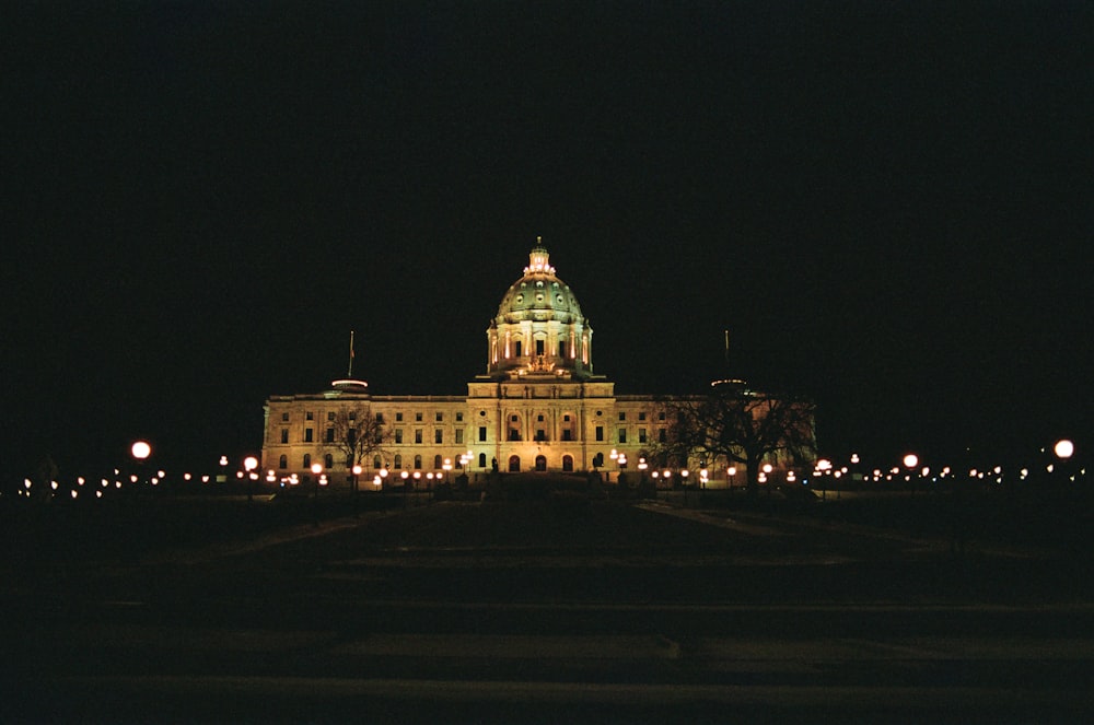 a large building lit up at night time