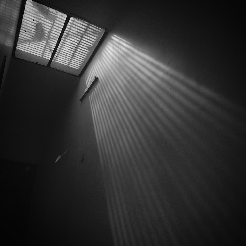 a room with a light coming through the window