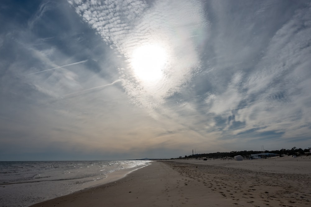 a sandy beach with footprints in the sand