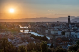 Smiling travelers enjoying a scenic sunset over a famous European landmark.