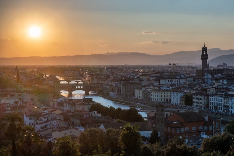A scenic view of a European city skyline at sunset.