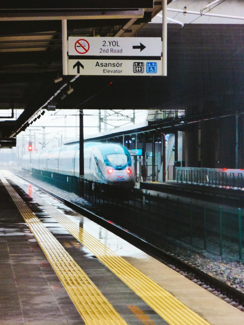 a train pulling into a train station next to a platform