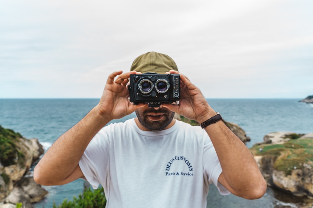 a man holding a camera up to his face